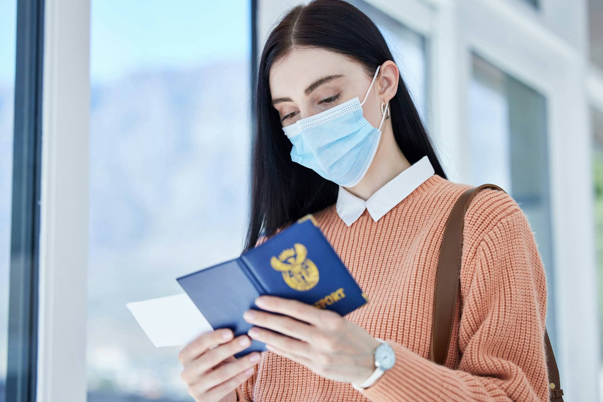 Passport, id and travel woman with covid face mask for immigration, airport compliance and vacation